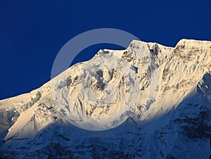 Mountain peak in the Annapurna ridge at sunset,