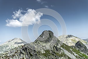 Mountain peak and a cloud on beautiful clear summer sky