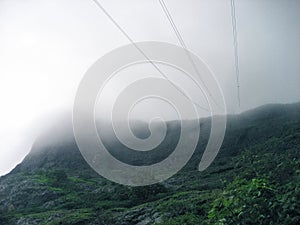 Mountain Peak Covered Partially Covered with Clouds