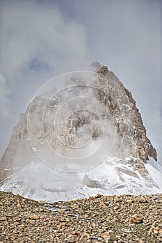 Mountain peak dressed in snow and volcanic rock from Upper Shimshal. Karakoram Himalaya