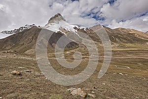 Mountain peak dressed in snow and volcanic rock from Upper Shimshal. Karakoram Himalaya