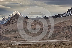 Mountain peak dressed in snow and volcanic rock from Upper Shimshal. Karakoram Himalaya