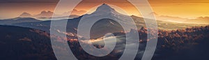 Mountain Peak With A Hazy Sunrise Backdrop Banner Background. Generative AI