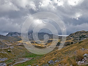 Mountain peak hidden by low nimbus clouds.