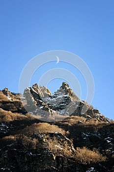 Mountain peak with moon