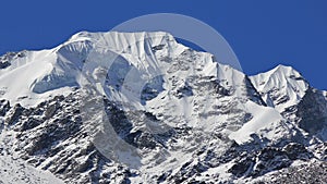 Mountain peak of Naya Kanga covered by thil glacier and snow. Vi