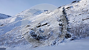 Mountain peak near Visitor centre on Trollstigen road in snow in Norway in autumn