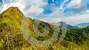 Mountain peak range landscape.  Green mountain range view. Mountain peak blue sky white clouds panorama