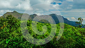 Mountain peak range landscape.  Green mountain range view. Mountain peak blue sky white clouds panorama