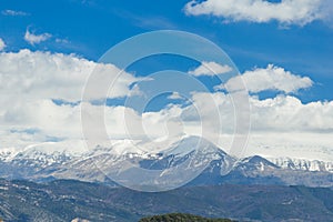 Mountain peak snow clouds blue sky, epirus Ioannina Greece Mitsikeli pea