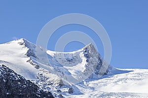 Mountain peak with snow and sunshine