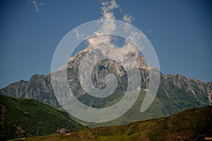 Mountain peak white clouds