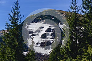 Mountain peaks with greenery and snow in Carpathians