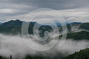 Mountain peaks with low clouds, fog or mist