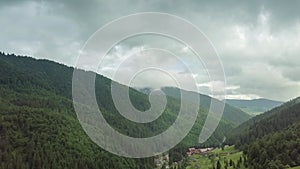 Mountain peaks and morning sky with smooth moving clouds. Summer landscape paeceful valley trees in the meadow at