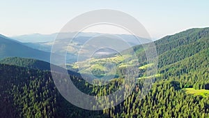 Mountain peaks and morning sky with smooth moving clouds. Summer landscape paeceful valley trees in the meadow at