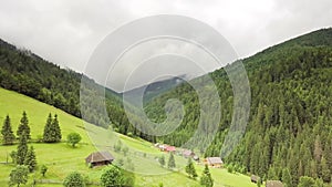 Mountain peaks and morning sky with smooth moving clouds. Summer landscape paeceful valley trees in the meadow at