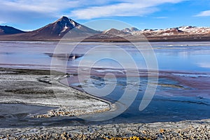 Mountain peaks reflected in the colorful waters of Laguna Colorada, in the Eduardo Avaroa National Reserve, Uyuni, Bolivia