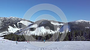 Mountain Peaks and Skiers on the Ski Slope. Slow Motion