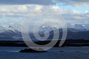 Mountain peaks stand out of the Norwegen water at the beautiful Lofoten islands. A ferry point of view photo