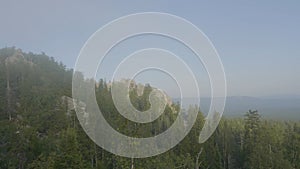 Mountain peaks view mountain forest trees. Mountainous terrain and forest in the fog. Beautiful forest and mountain photo