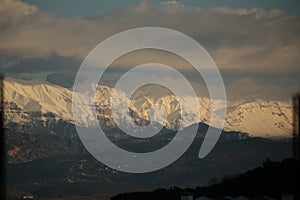 mountain pick with snow on top clouds ice winter background in mitsikeli mountain grreece