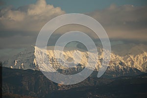 mountain pick with snow on top clouds ice winter background in mitsikeli mountain grreece