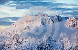 Mountain portrait Birnhorn Saalbach sunset purple light clouds snowy mountain