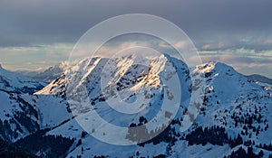 Mountain portrait Saalbach sunset clouds perfect blue sky purple light snowy mountainscape