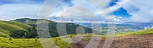 Mountain range clouds panoramic landscape.