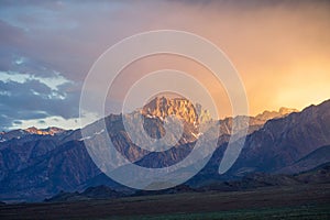 Mountain range colorful sunset with clouds before storm