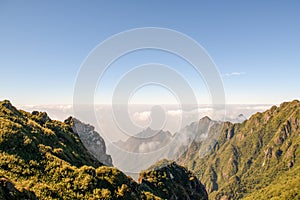 Mountain range with fog and blue sky