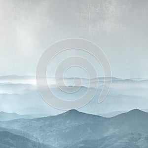 Mountain range in the fog - horizon background in grey blue vintage style