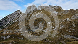 Mountain range and hut on pass road to Mangart saddle in Slovenia