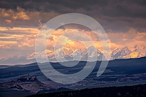 Mountain range landscape view with Spis castle at sunrise, High Tatras, Slovakia