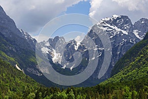 Mountain range and the peak of the Mount Mangart seen from Fusine Lake, Italy.