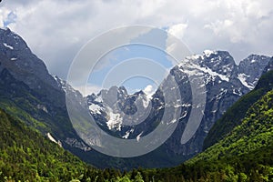 Mountain Range and the peak of the Mount Mangart seen from Fusine Lake, Italy.