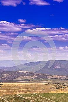 Mountain range with snow-white clouds on a blue sky