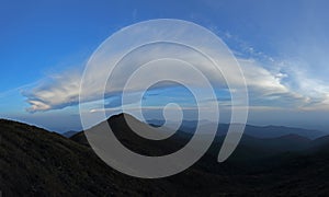 mountain range tropical rainforest canopy at southern of Thailand with more cloud background blue sky