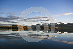 Mountain reflected in cold water of Balsfjord, Norway