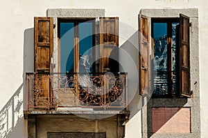 Mountain reflection in classic apartment balcony windows with op