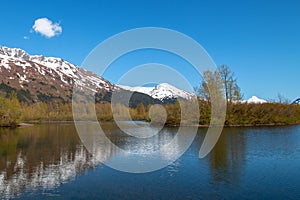 Mountain reflections at Moose Flats Wetland and Portage Creek in Turnagain Arm near Anchorage Alaska USA