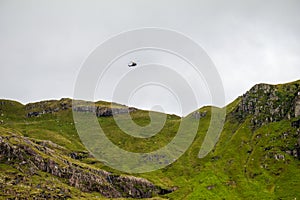 mountain rescue helicopter searching mountain side