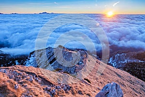 Mountain ridge above clouds