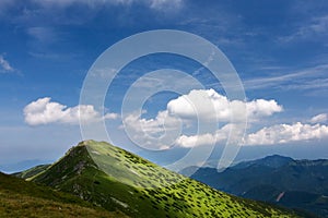 Mountain ridge and blue sky with clouds