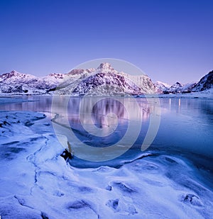 Mountain ridge and reflection on the lake surface. Natural landscape on the Lofoten islands, Norway.