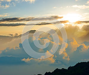 mountain ridge silhouette in dense mist and clouds