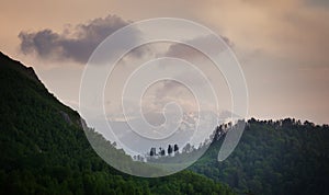 Mountain ridges at against the sky with clouds