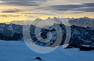 Mountain ridges in the rays of sunset in the Caucasus