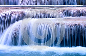 Mountain river background with small waterfalls